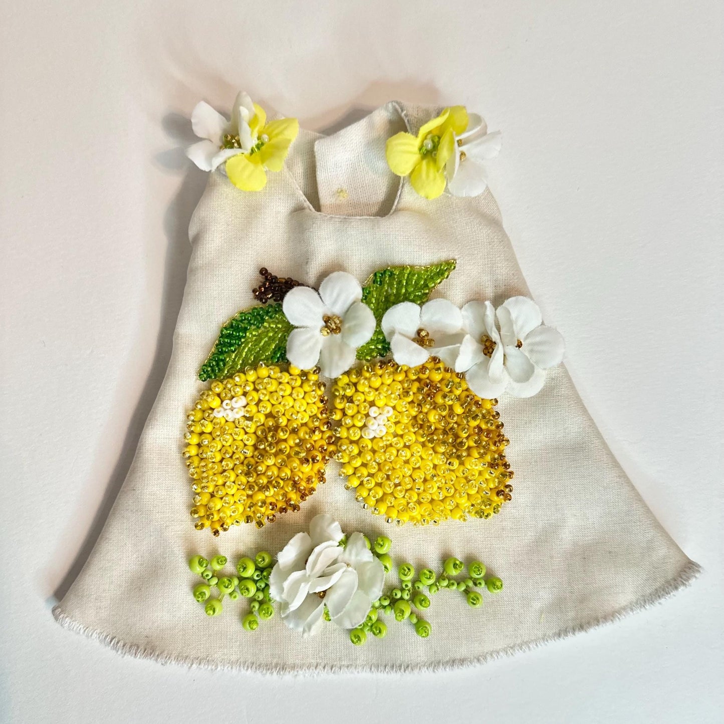 Collectible Doll dress with floral and lemon decorations on a light background