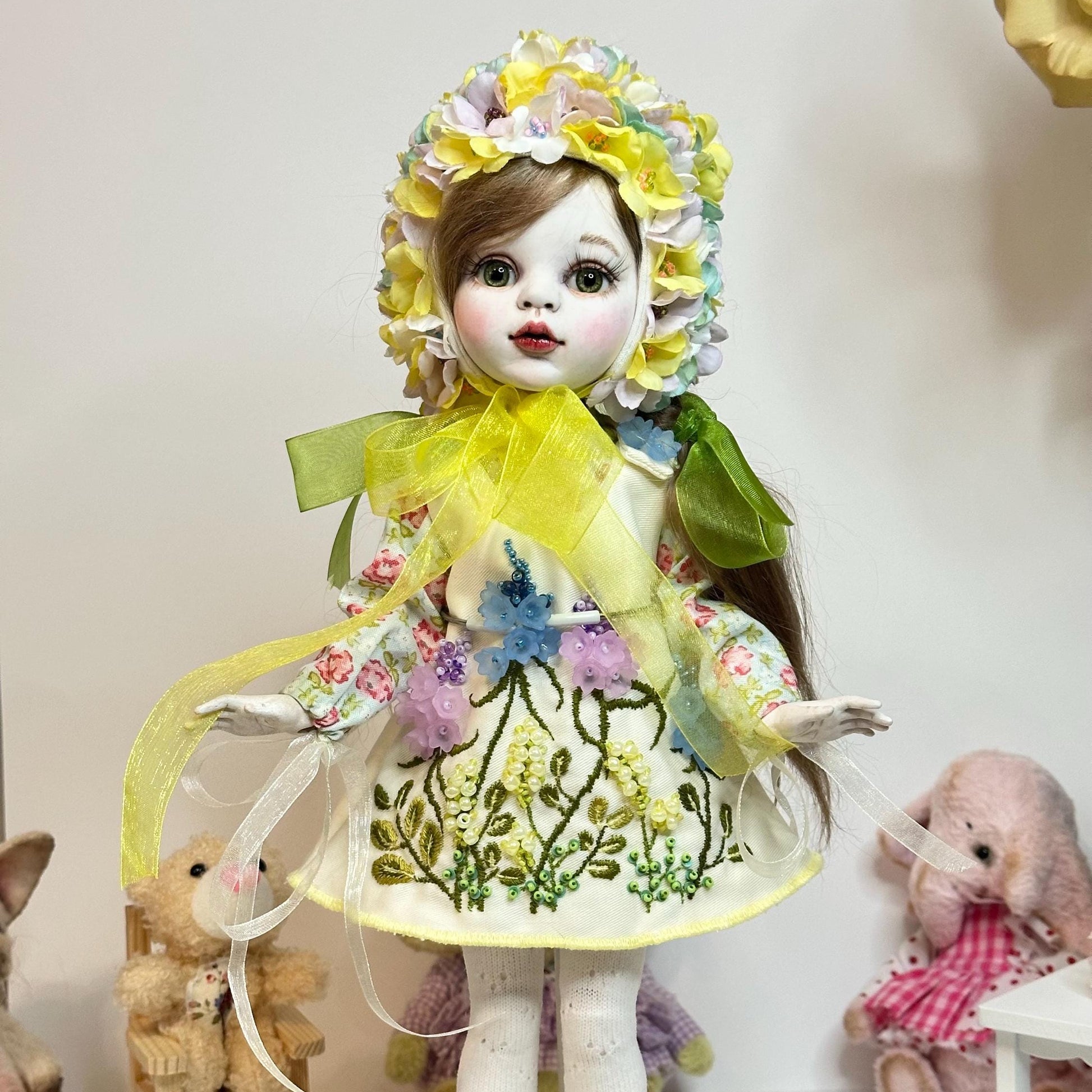 Artistic doll with floral dress and headpiece in a decorative setting with toys.